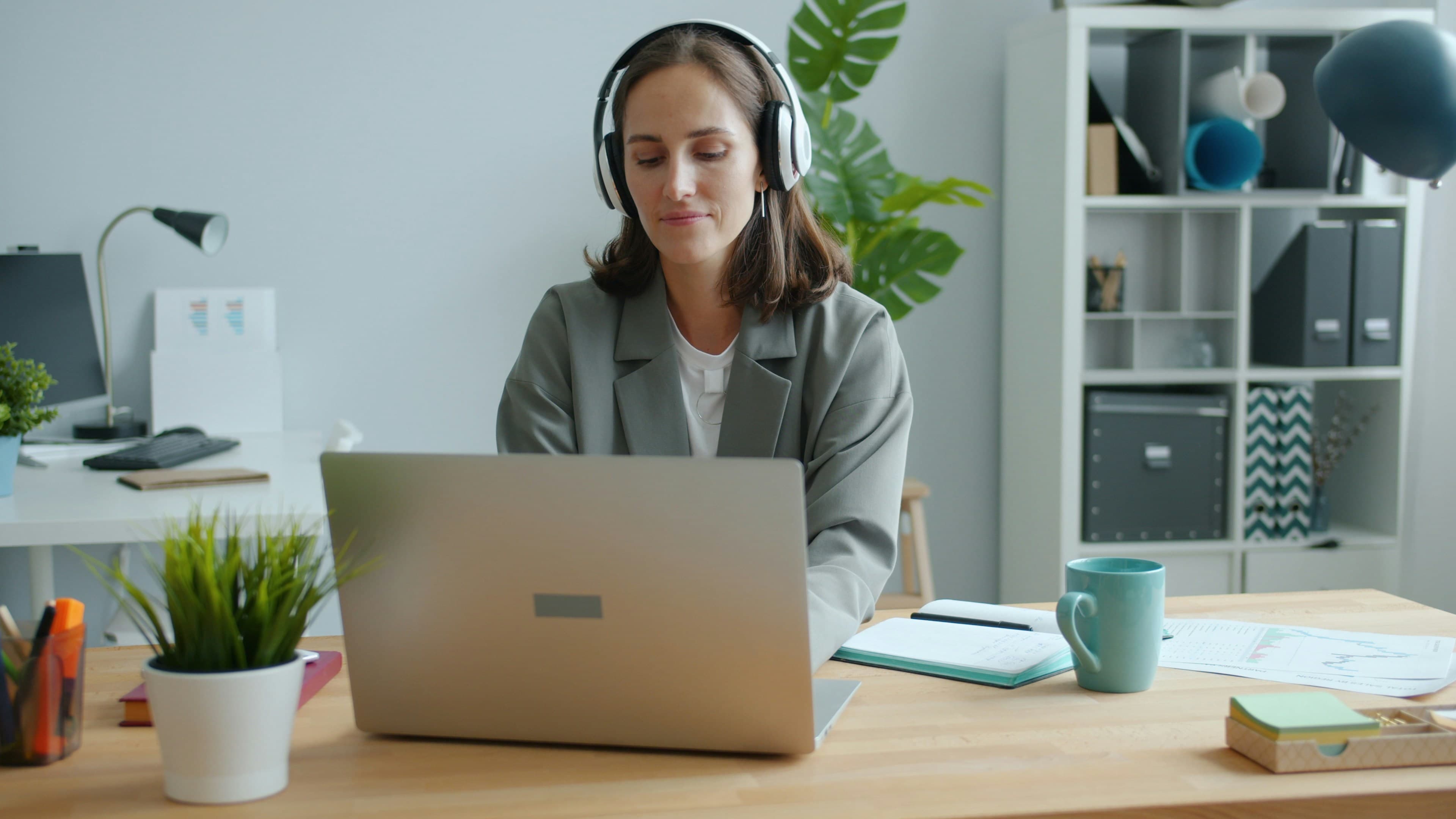 Lux 24/7 personal assistant taking a member's call while working on a laptop
