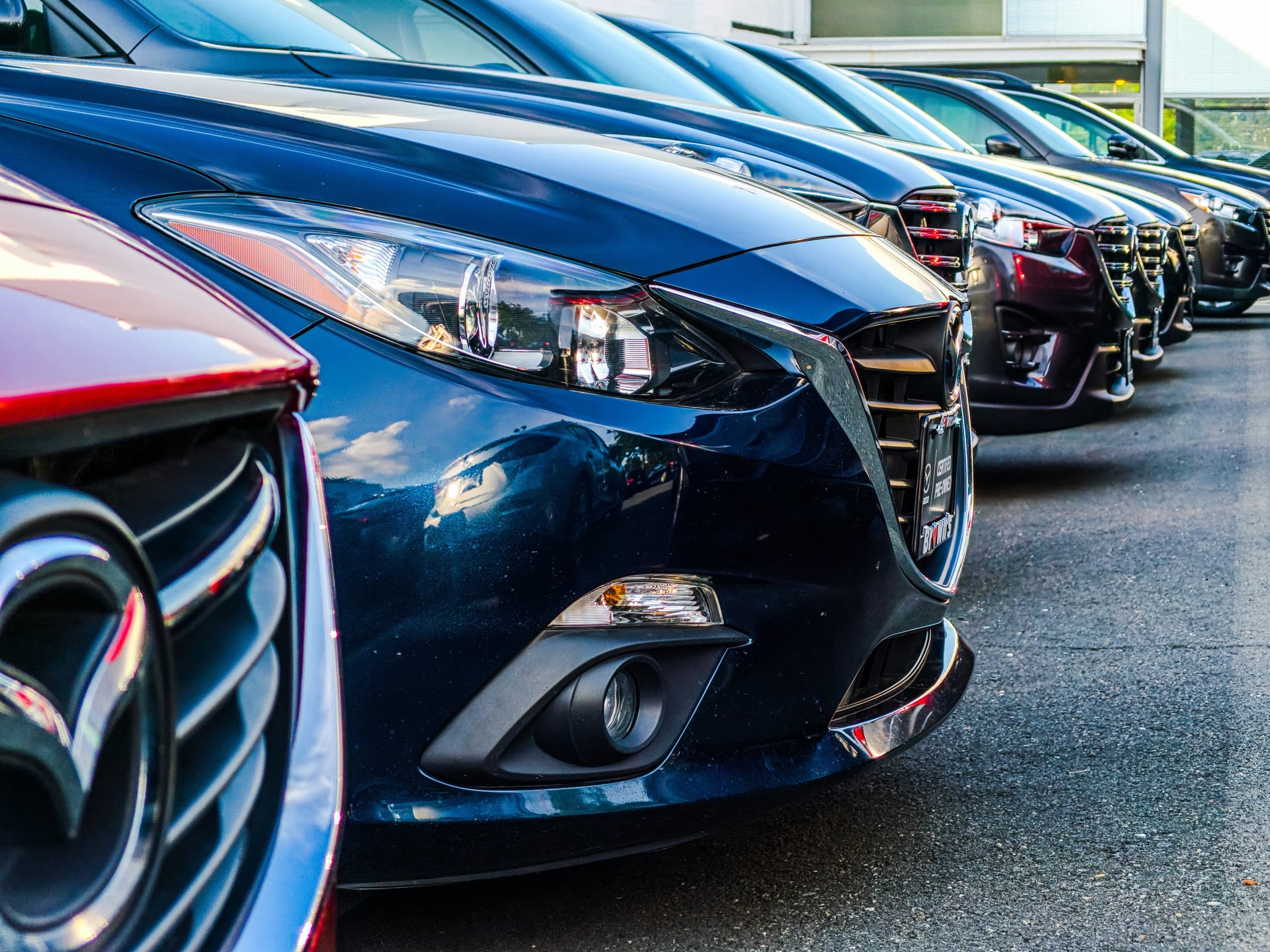 Row of rental cars lined up at a car rental pickup location