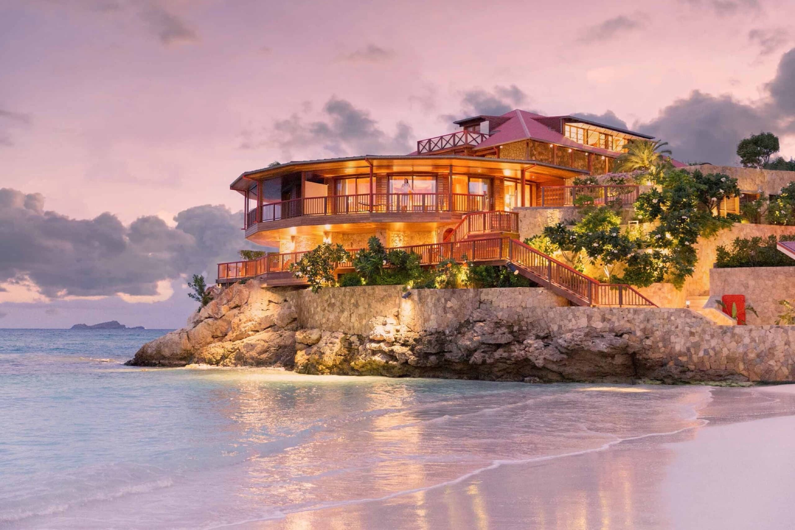Eden Rock hotel glowing at dusk above the beach in St. Barths