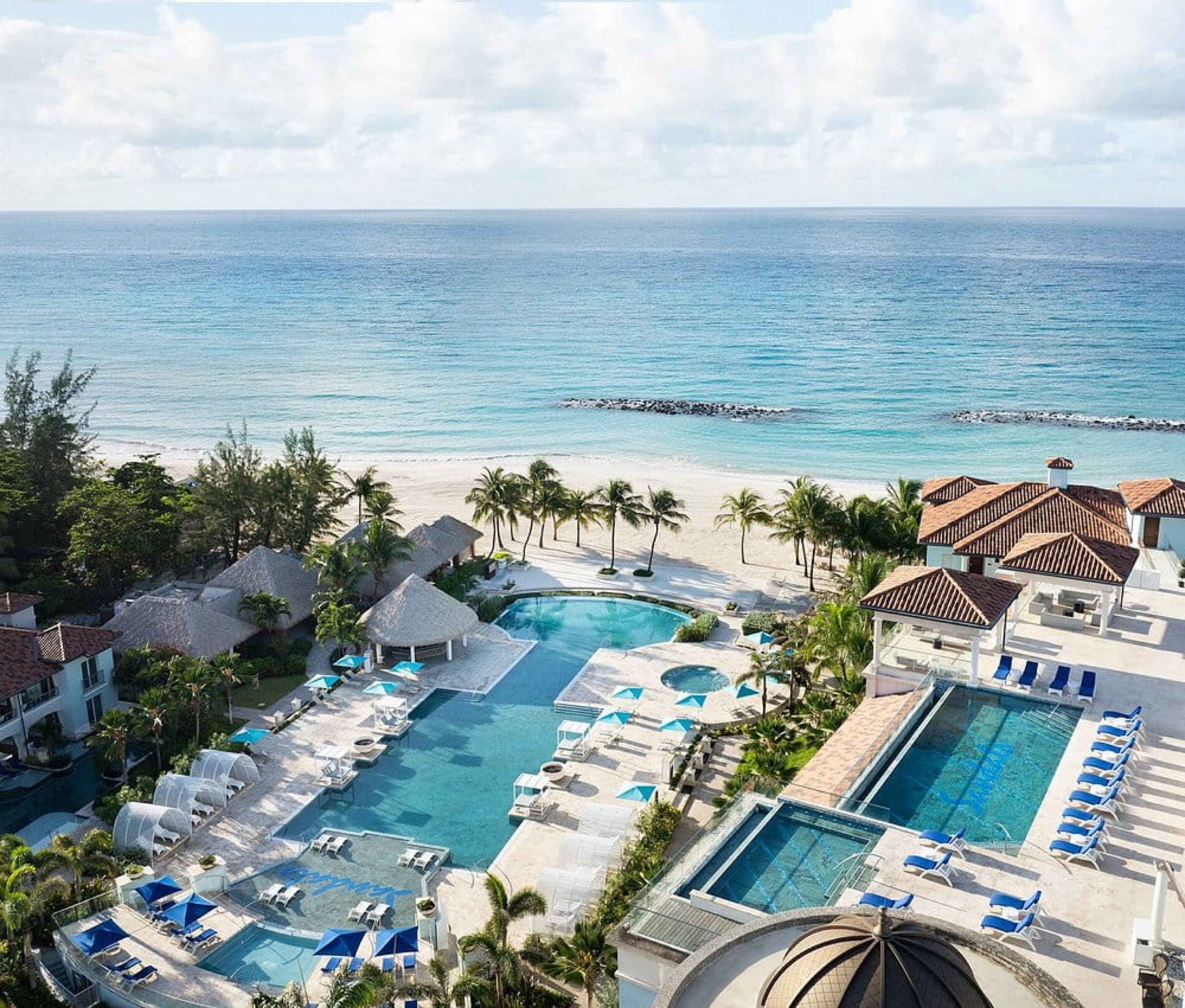 Aerial view of beachfront pools and white-sand beach at Sandals Royal Barbados all-inclusive resort