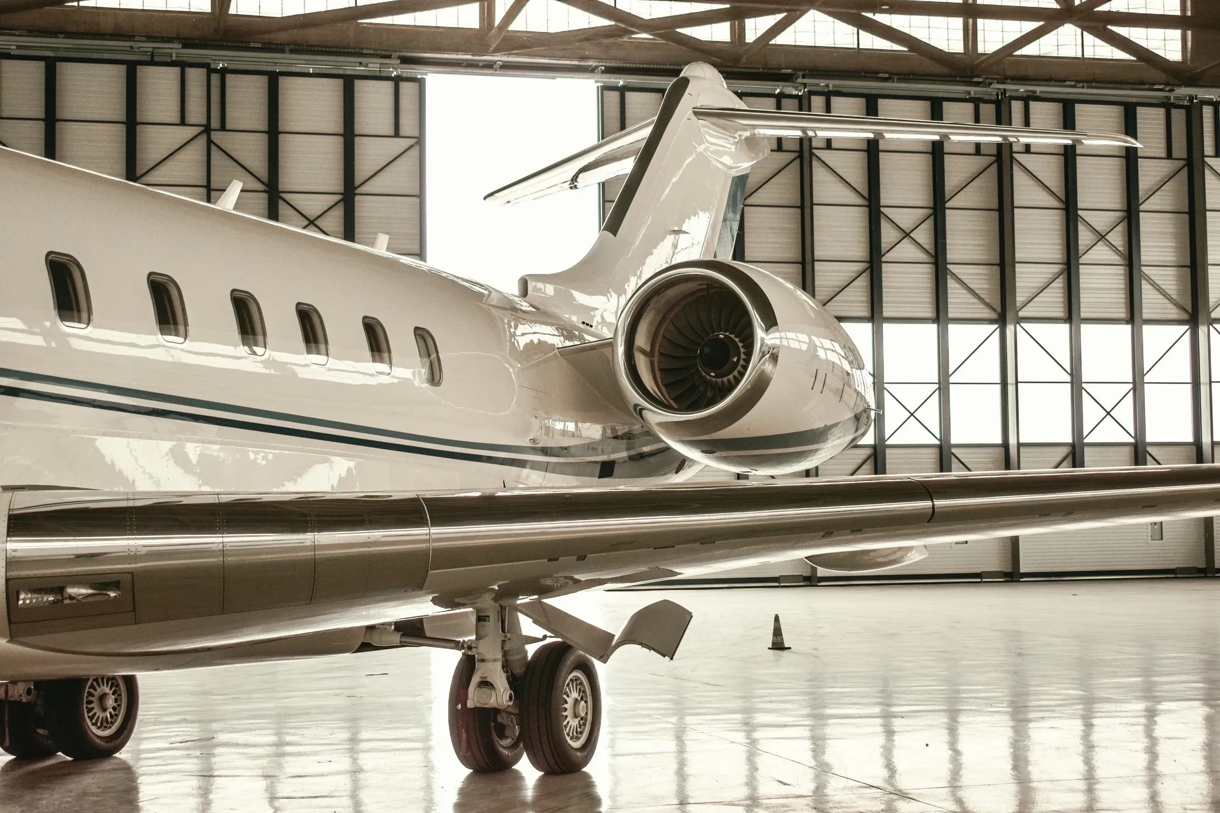 A private jet in a hangar, seen from beside its engine