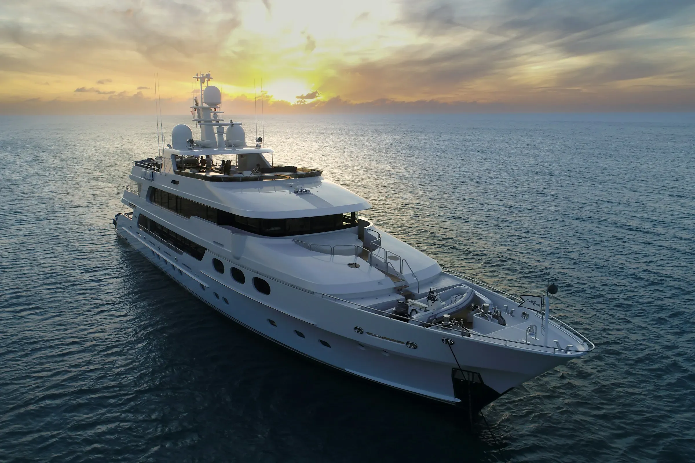 A superyacht on calm open water at dusk